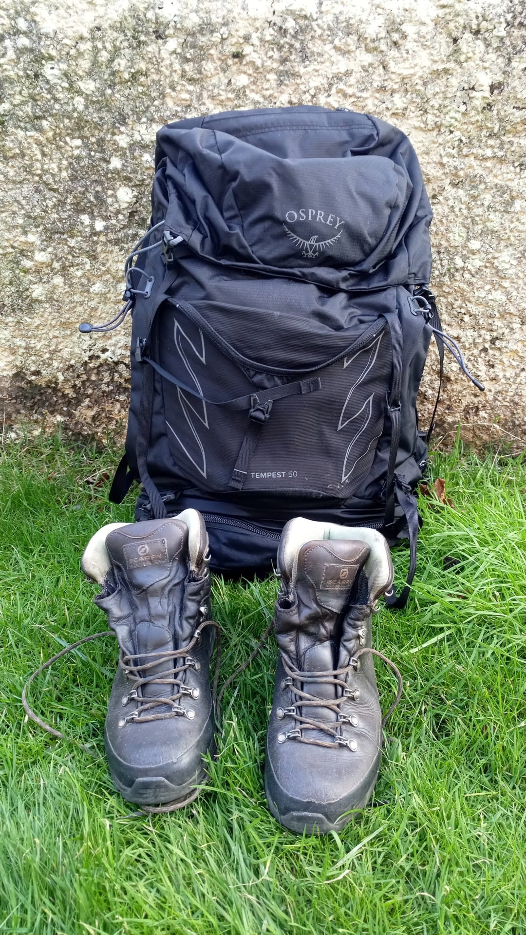 A black rucksack and hillwalking boots